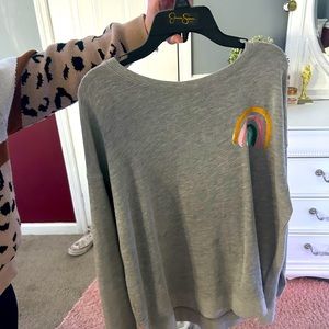 This is a grey crew neck with a rainbow on the back and in the right corner.